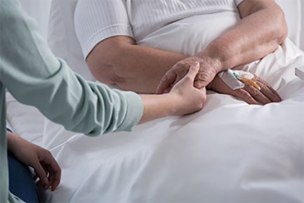 Caregiver holding patient's hand