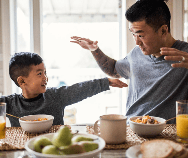 medical research lab Father playing with young son at breakfast table