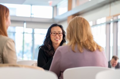 Woman conversing with another woman
