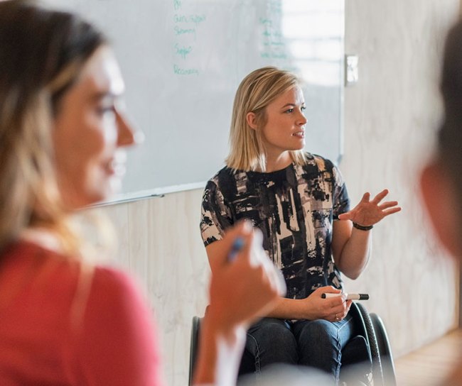 woman in wheelchair making presentation