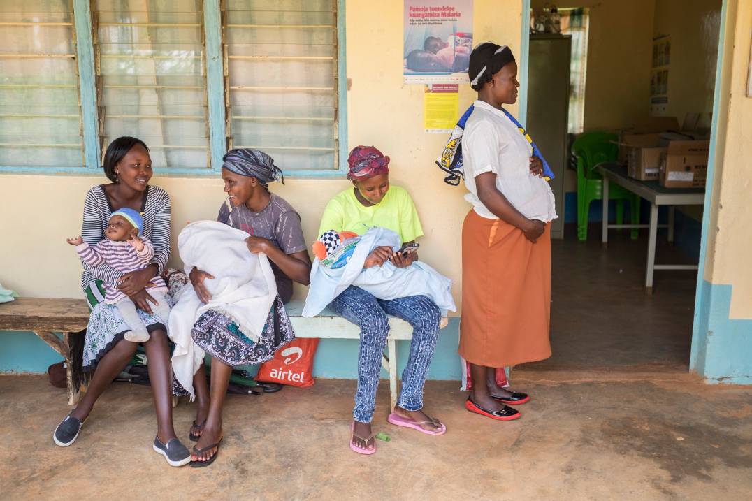 women in line sitting in bench
