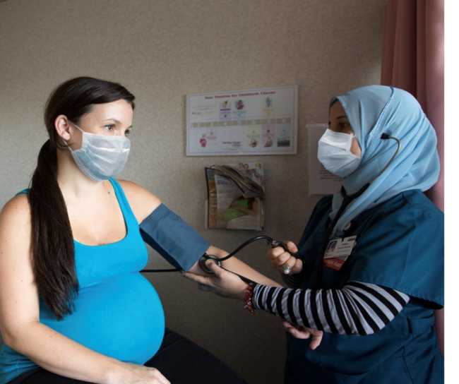 nurse checking blood pressure on pregnant women