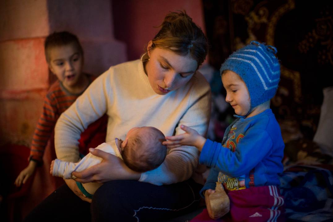 Mother with her baby and toddler in Romania