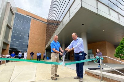 Tom McCubbins, SVP, operations, and Mike Kress, SVP, chemistry, cut the ribbon to unveil the new West Point site expansion