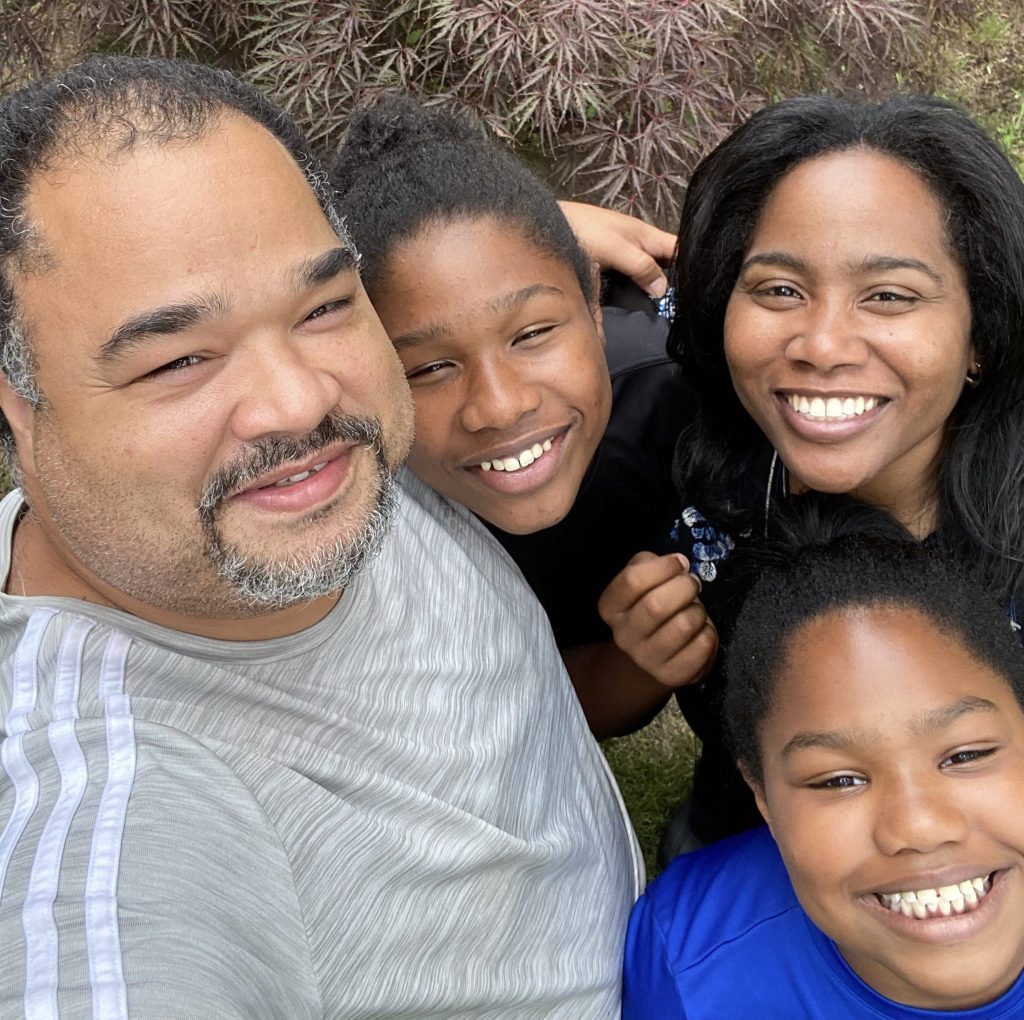 Woman, man and two children smiling