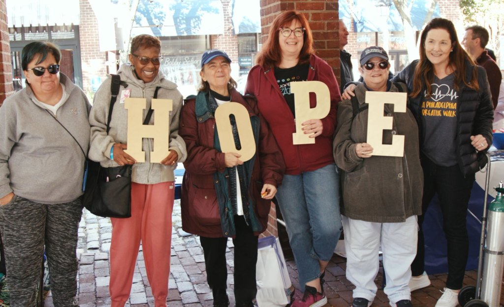 Colleen and her support group holding a hope sign