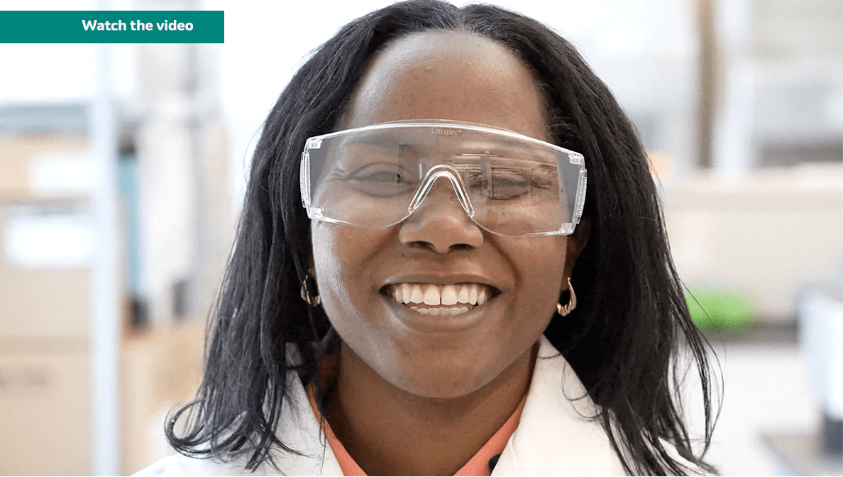 Merck scientist Denarra Simmons wearing goggles and lab coat