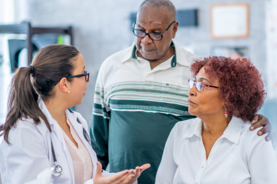 health care provider talking with older man and woman