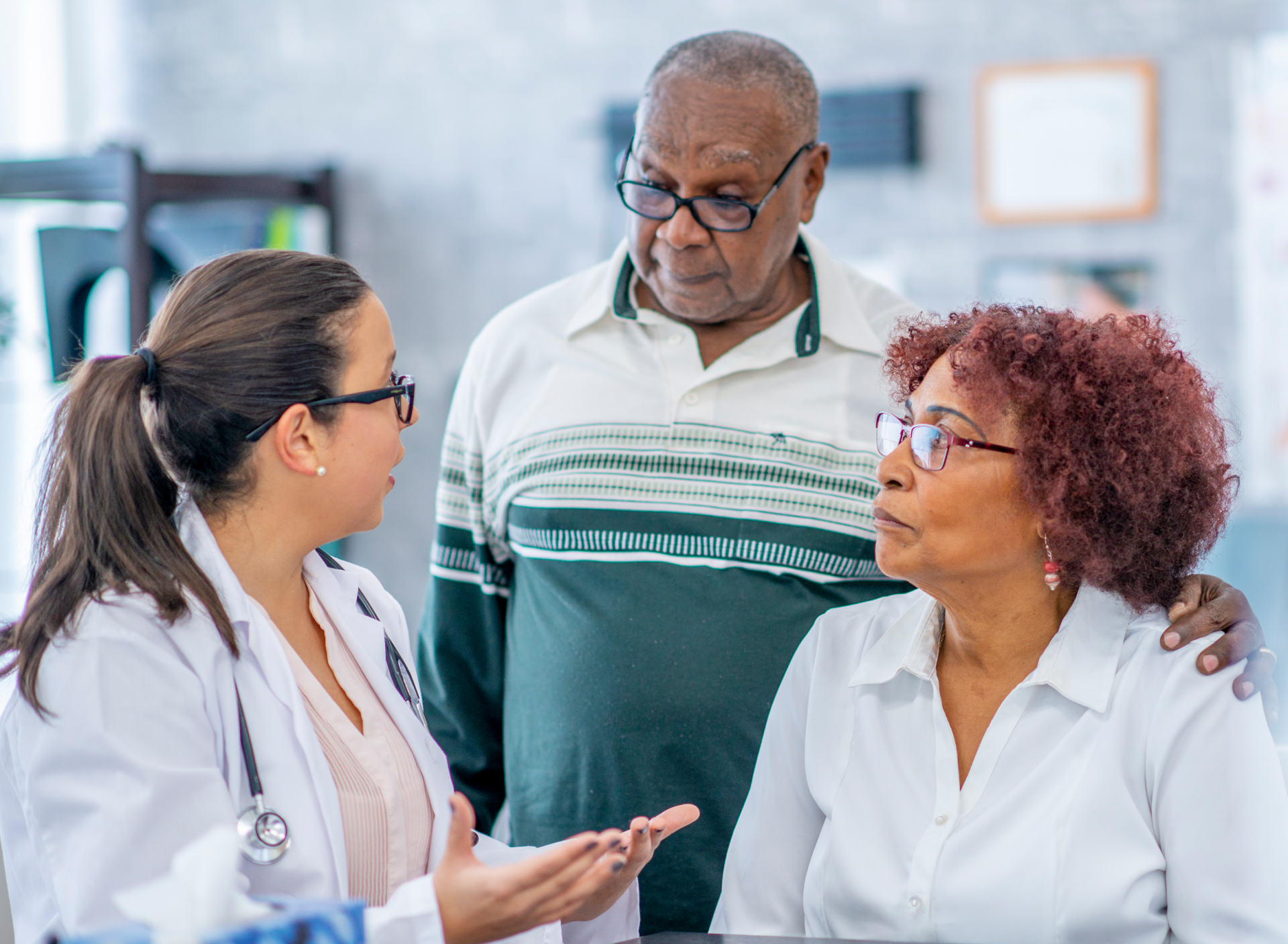 health care provider talking with older man and woman