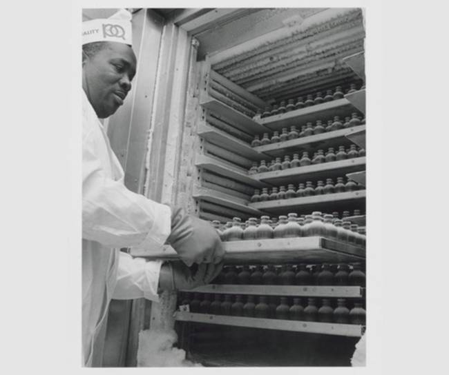 scientist taking out trey of vial