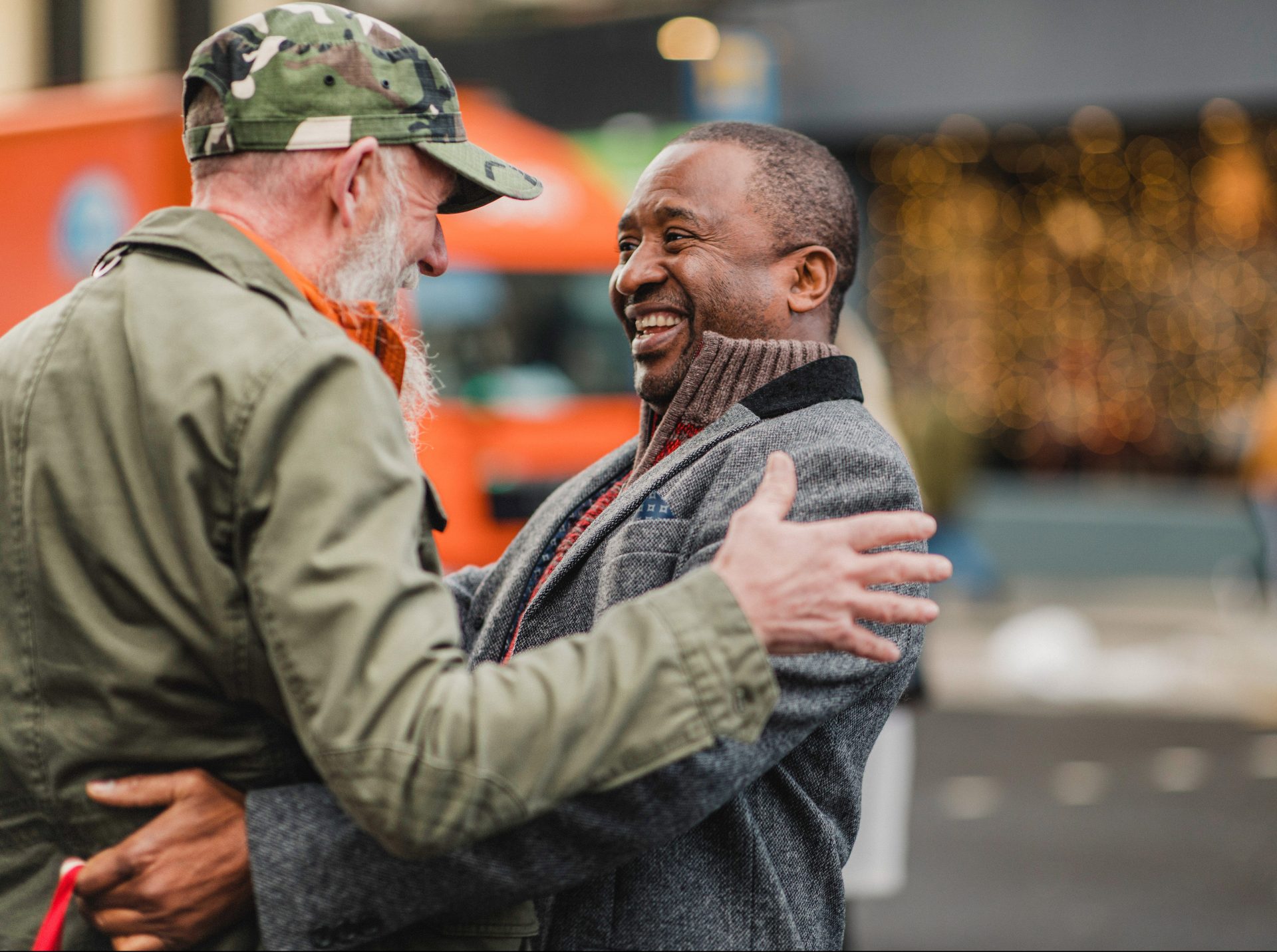 two men greeting each other with happy faces