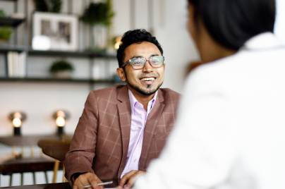 man in suit smiling at the person across
