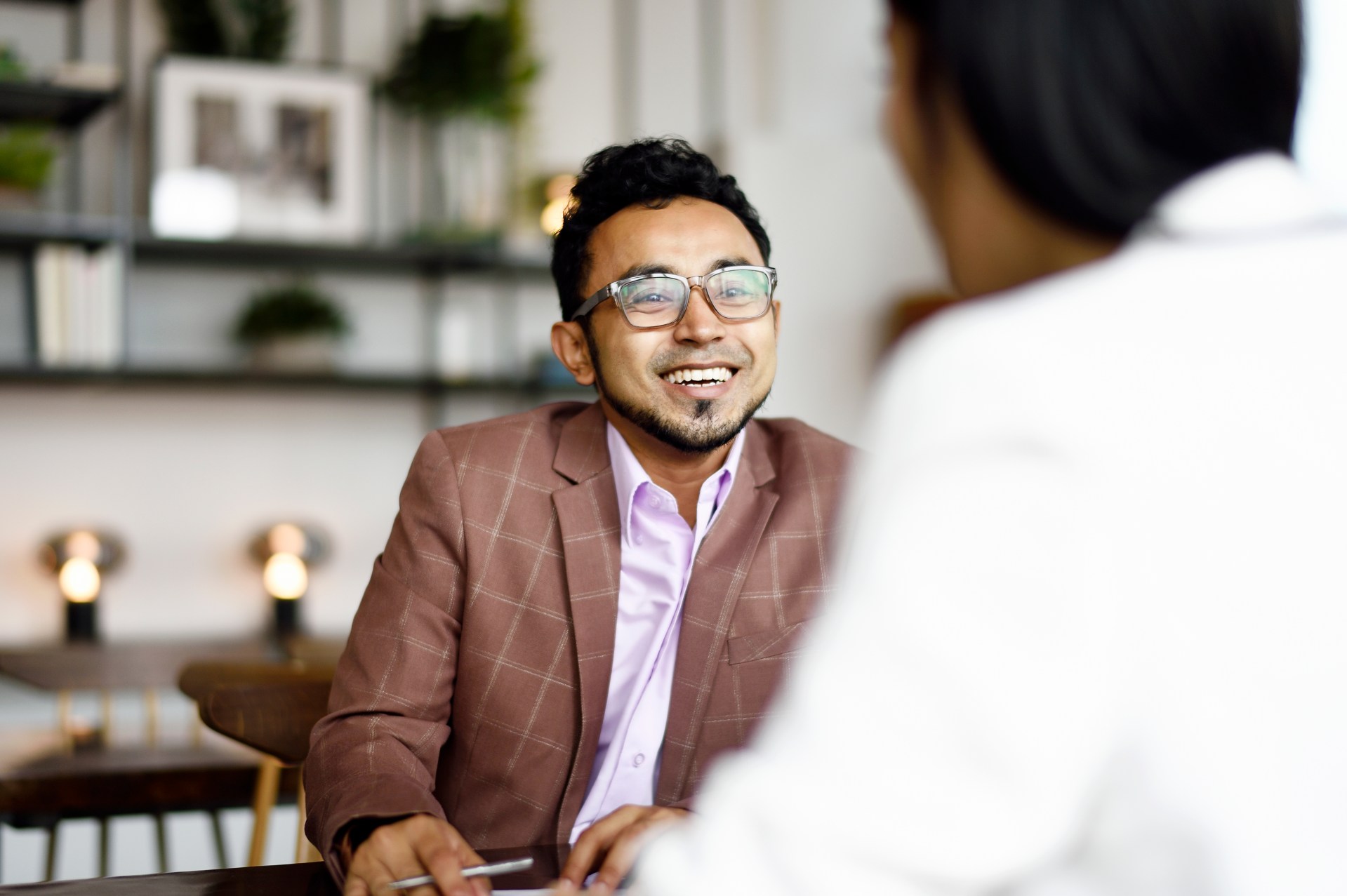 man in suit smiling at the person across