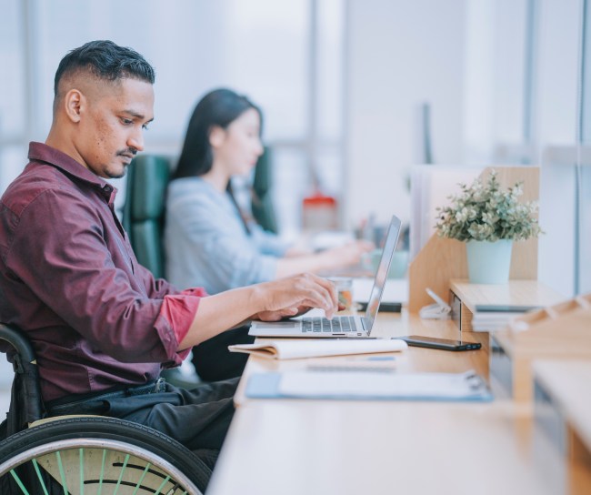 man in wheelchair working