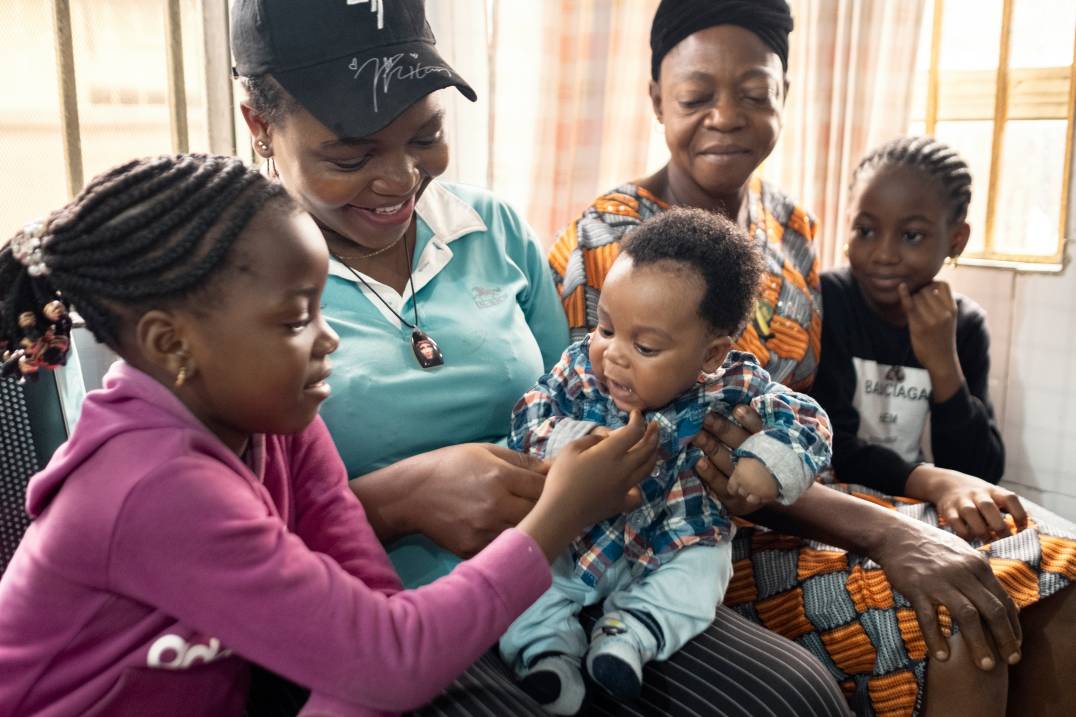 women smiling with children