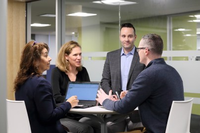 four colleagues meeting in the office