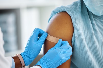 healthcare working putting a bandaid on a child's arm