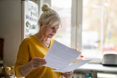 Senior woman filling out financial statements