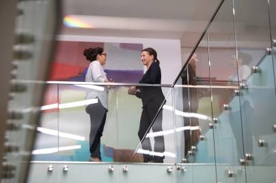 two women talking in an office building