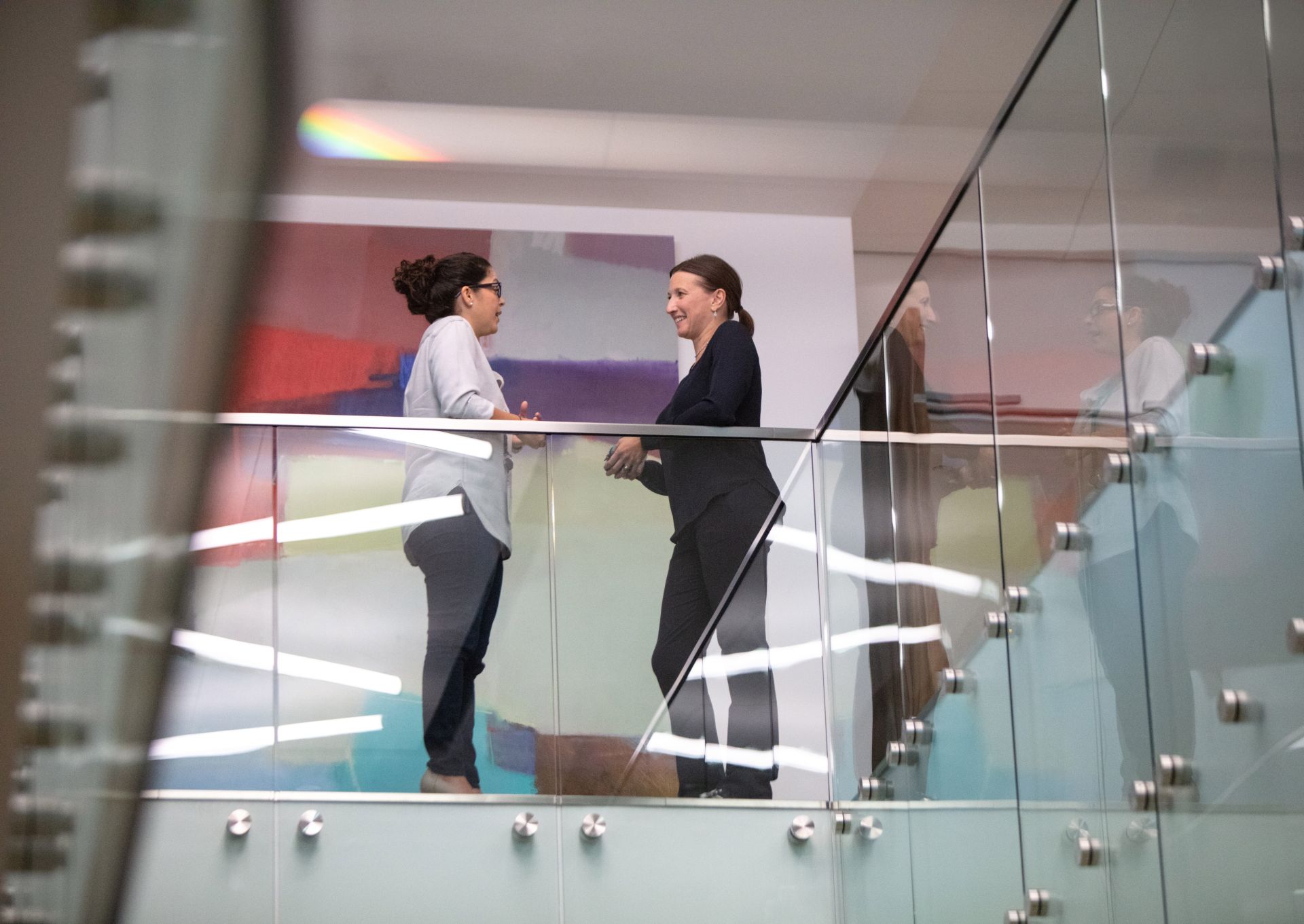 two women talking in an office building