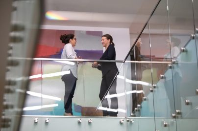 two women talking in an office building