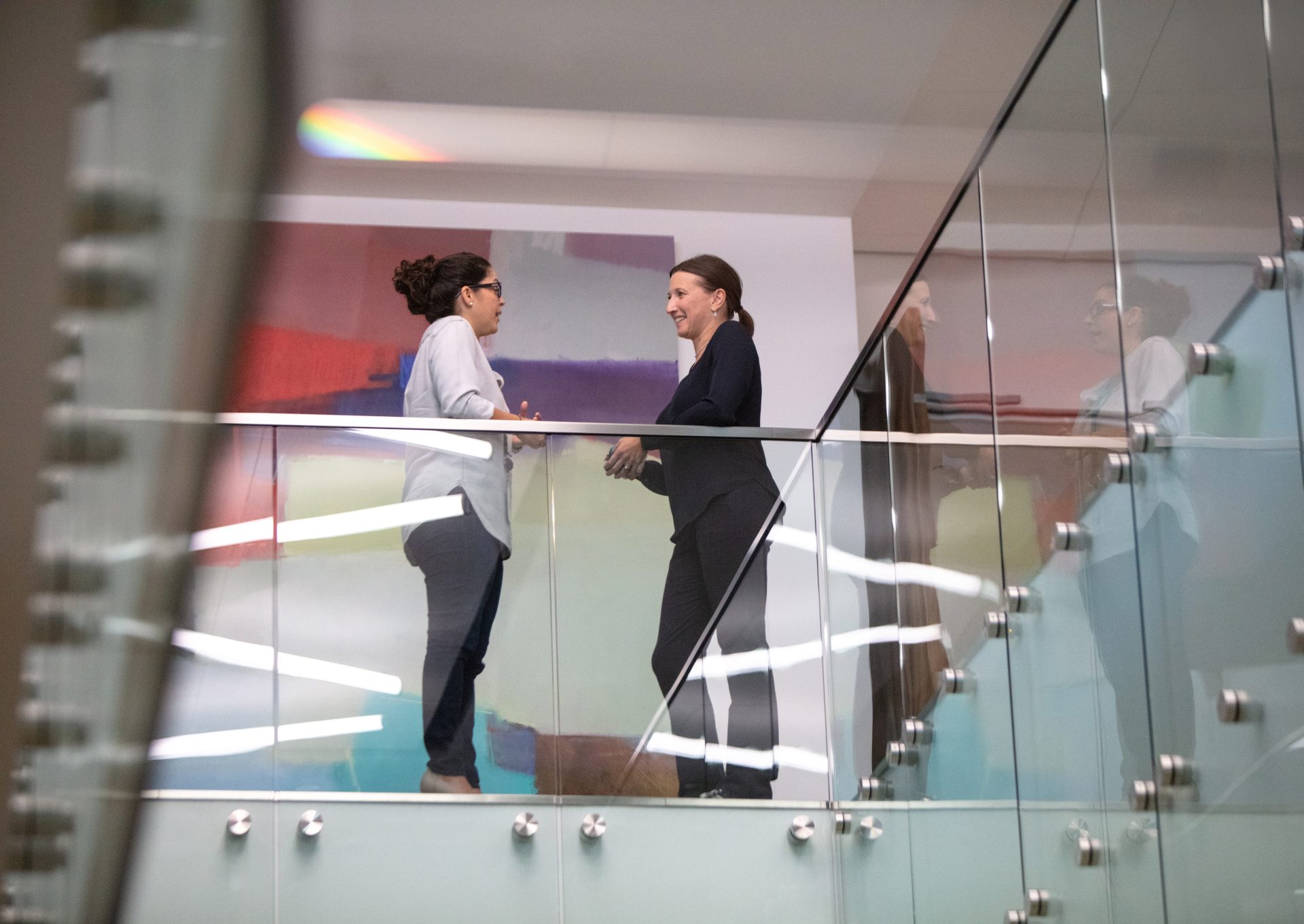 two women talking in an office building