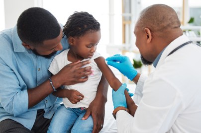 Boy child getting vaccine by doctor