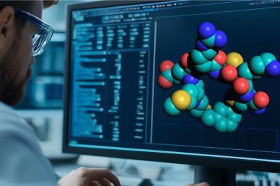 Person viewing a computer screen displaying a 3D molecular