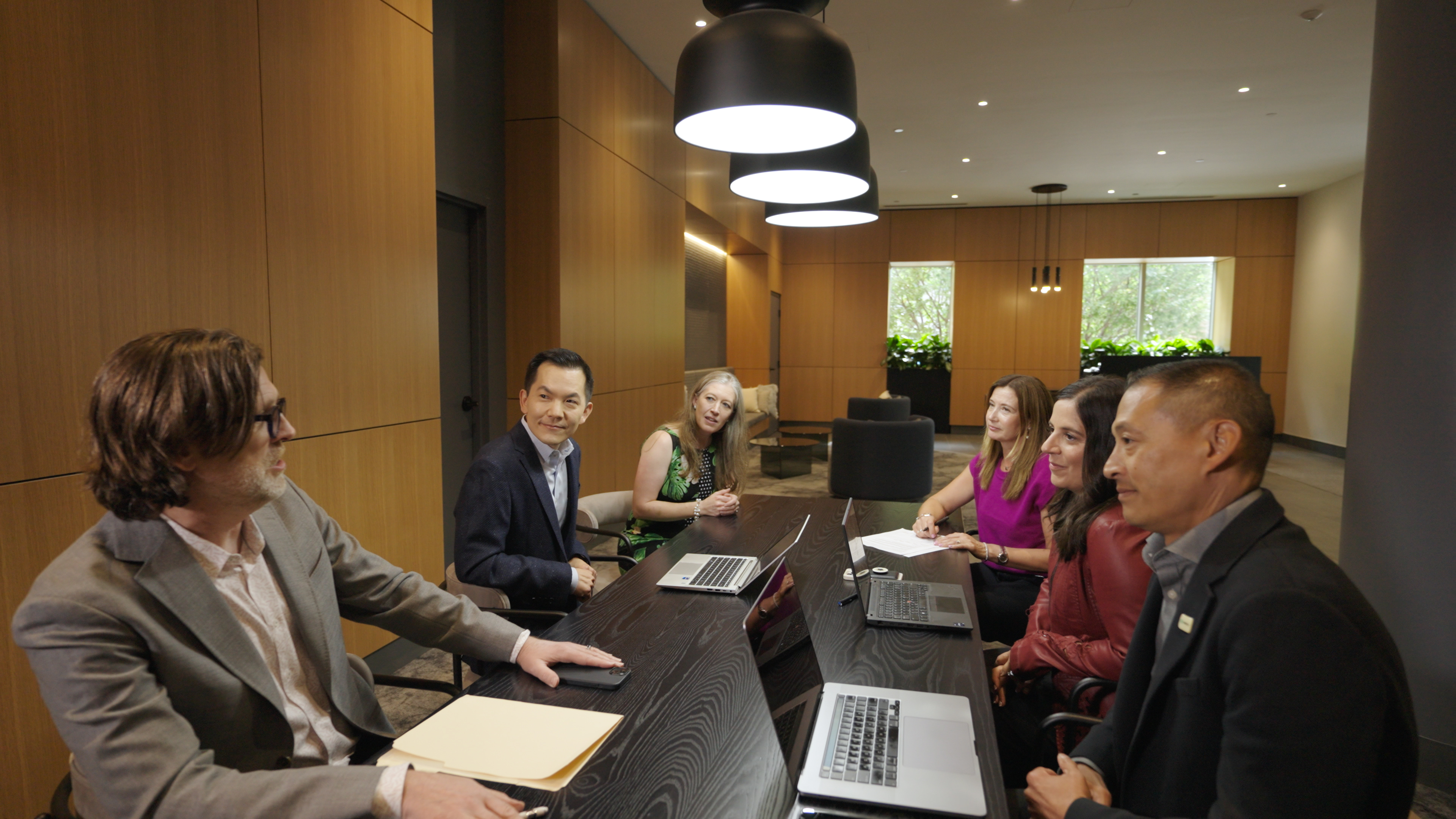group of colleagues talking in a conference room