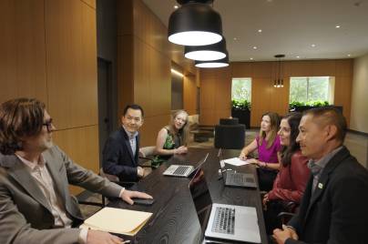 group of colleagues talking in a conference room