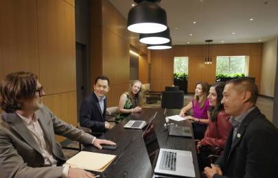group of colleagues talking in a conference room