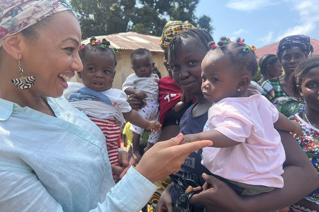 mothers holding their child while standing outdoors