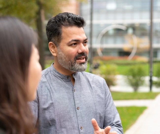 man with grey shirt outside a building