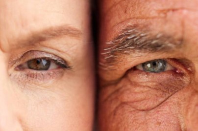 Close-up of two eyes side by side, showing contrast in skin tone and eye color between two individuals.