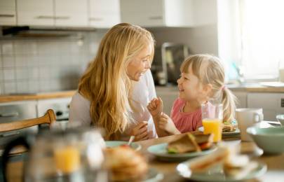 Woman and child sitting at table smiling