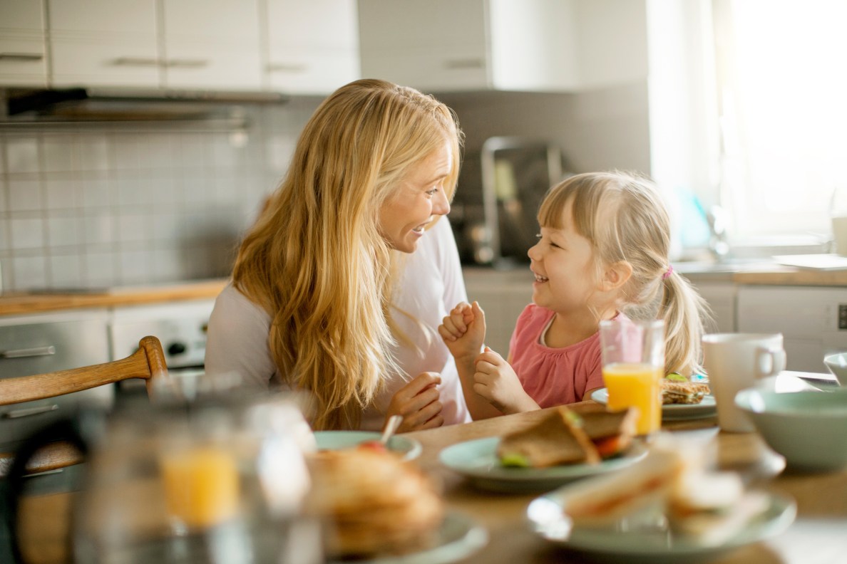 Woman and child sitting at table smiling
