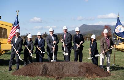 6 people wearing hardhats and holding shovels