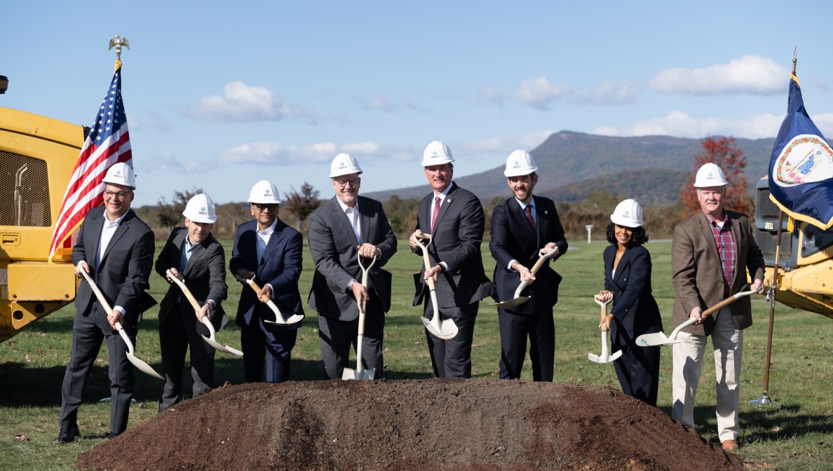 6 people wearing hardhats and holding shovels