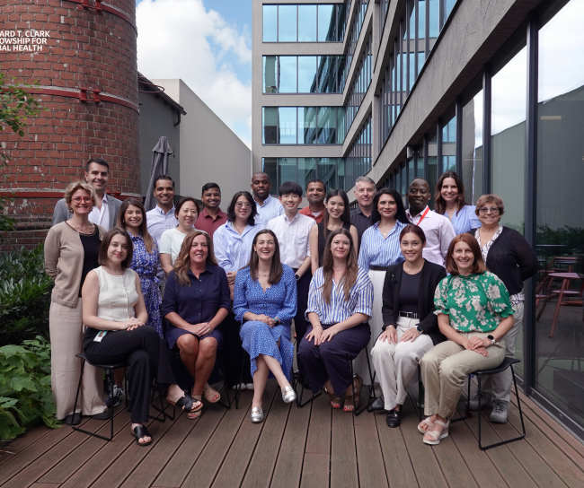 group of about 20 people smiling for the photo