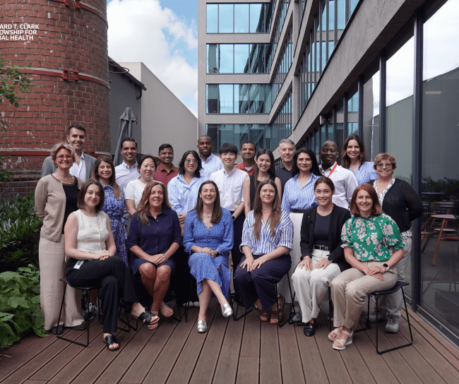 group of about 20 people smiling for the photo