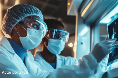 Scientists in lab with goggles, mask and lab coats