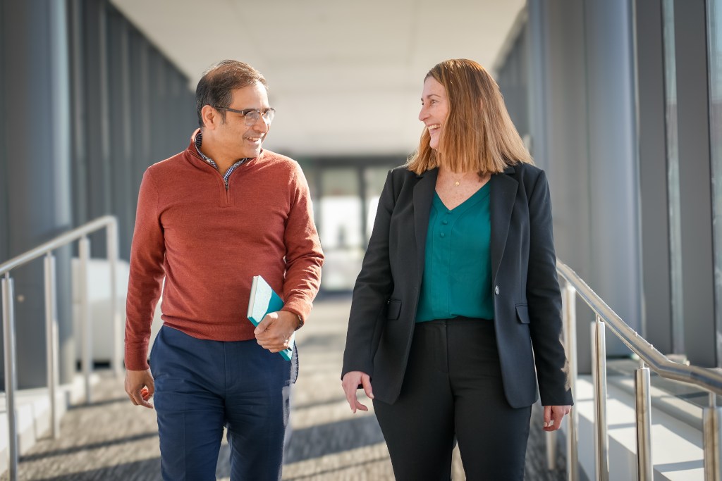 Photo of Merck colleagues Shuvayu Sen and Melissa Santorelli walking in the office
