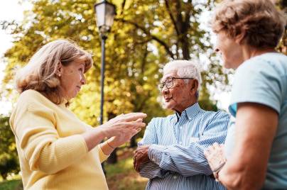 group of older adults outside talking