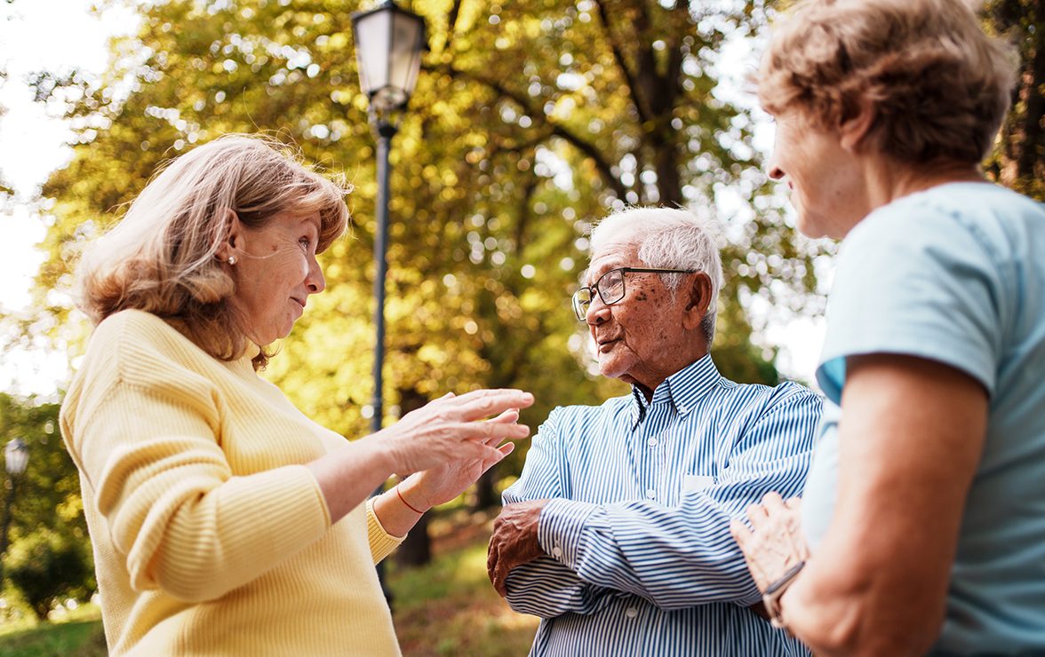 group of older adults outside talking