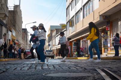 Four women crossing a city street