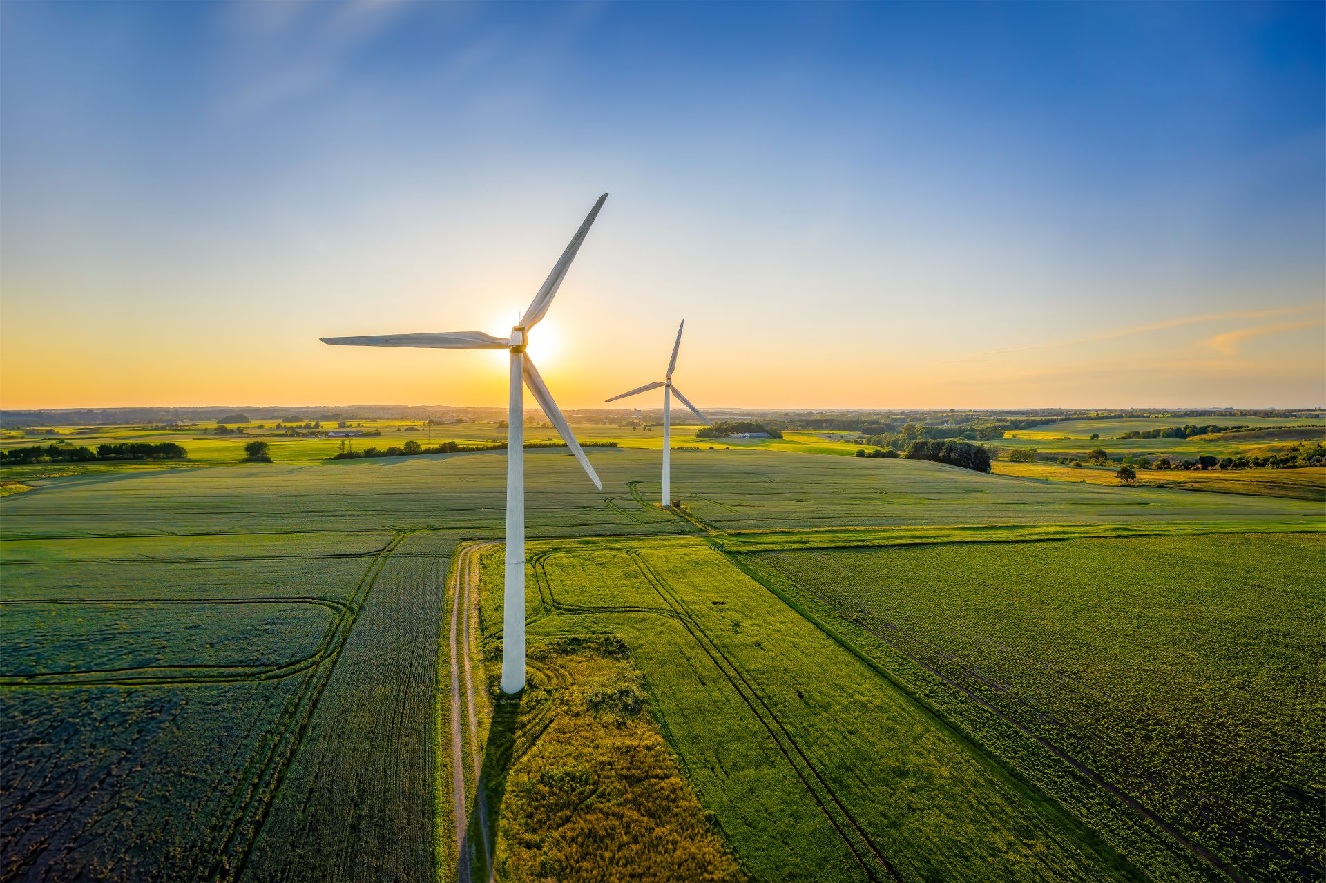 Wind turbines in a green field with a blue sky