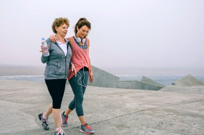 two women walking on beach