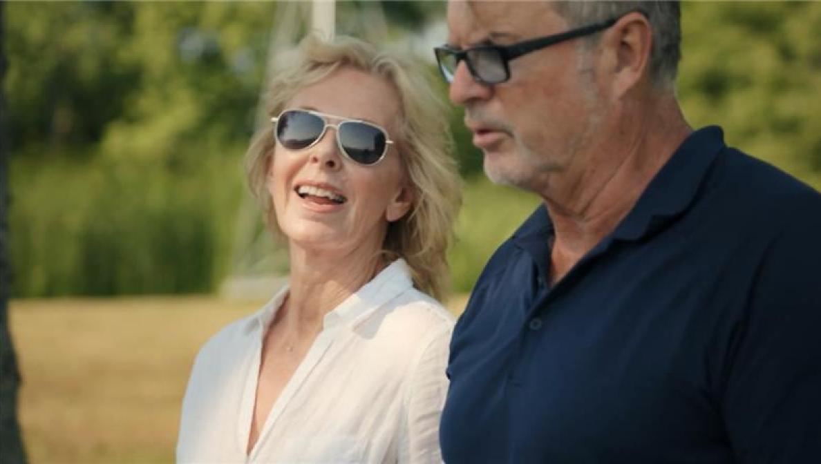 a man and woman smiling and talking