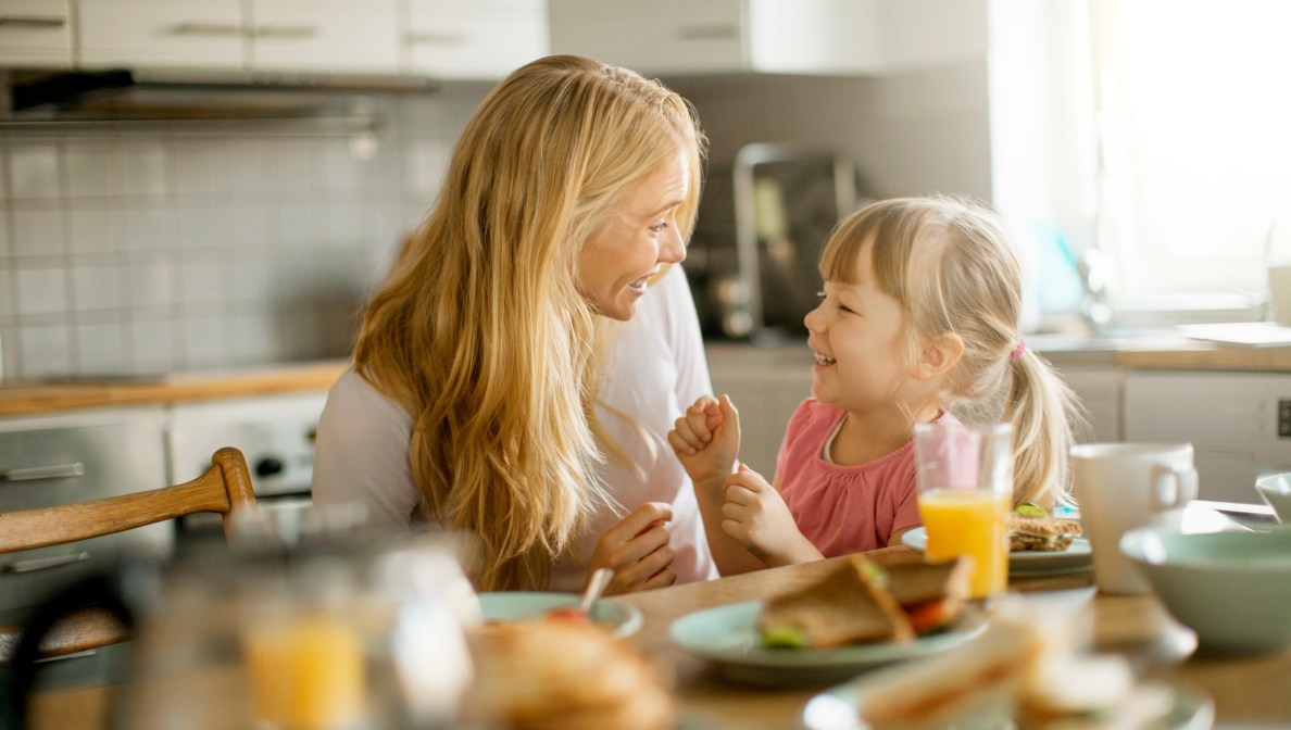 Woman and child sitting at table smiling